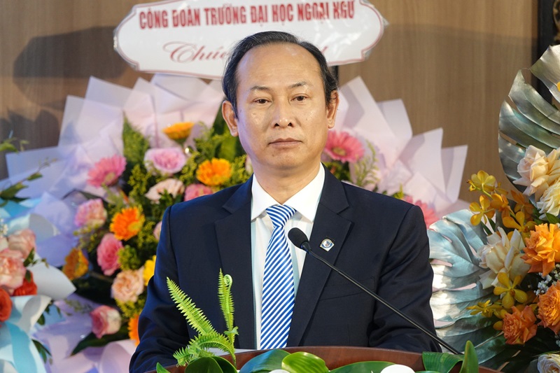 A person in a suit and tie standing at a podiumDescription automatically generated